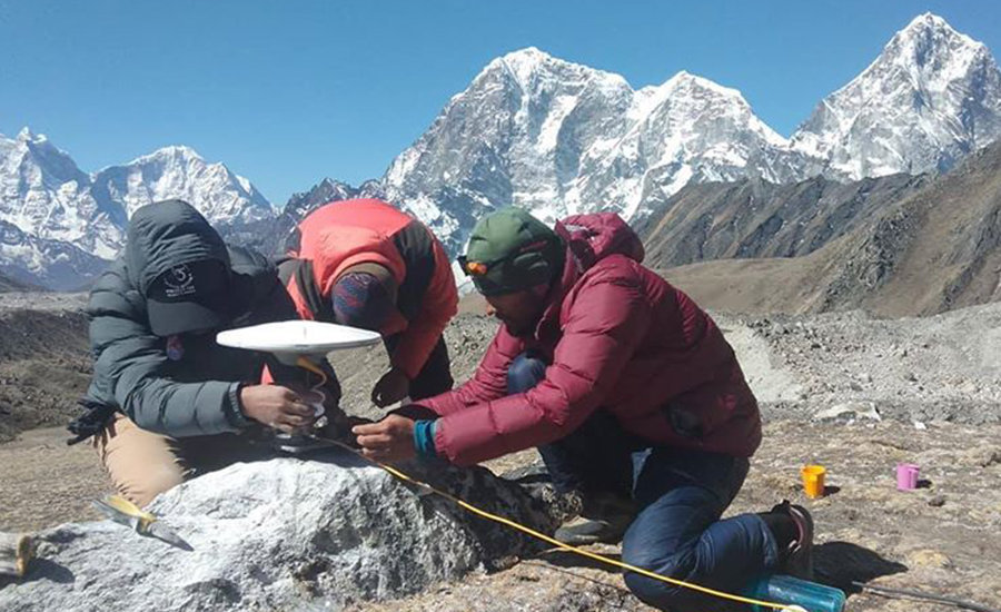 Nepalese mesuring height of Mt. Everest
